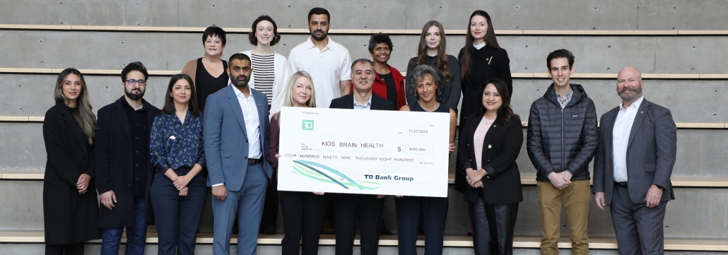 KBHN, TD, and SFU research team (Ali, Behnaz Bahmei, Dr. Elina Birmingham, Dr. Siamak Arzanpour, Kenzi, Ashkan Tavassoli, Meryssa Waite) standing with cheque at SFU Surrey.